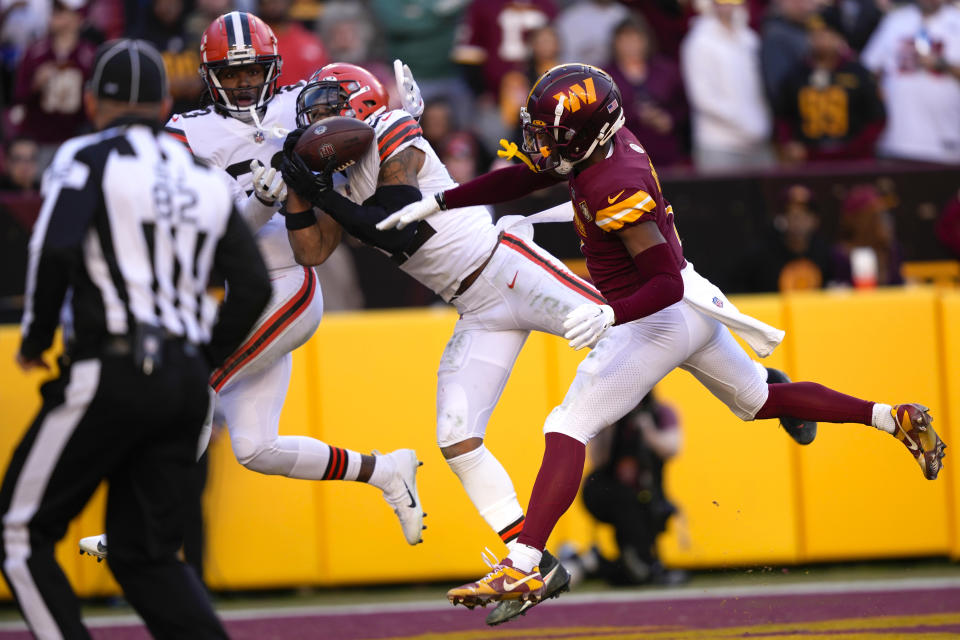Cleveland Browns safety Grant Delpit (22) intercepts a pass intended for Washington Commanders wide receiver Jahan Dotson (1) during the second half of an NFL football game, Sunday, Jan. 1, 2023, in Landover, Md. (AP Photo/Susan Walsh)