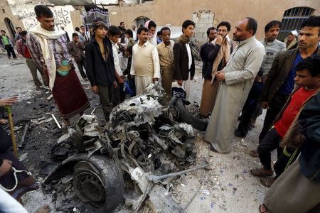 People gather at the site of a car bomb attack in Sanaa June 30, 2015. REUTERS/Khaled Abdullah