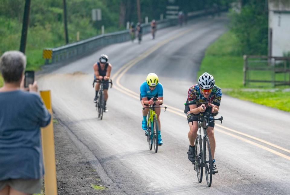 Cyclists cruise along Jacksonville Road with cheers from community members during the Ironman 70.3 Pennsylvania Happy Valley on Sunday, June 30, 2024.