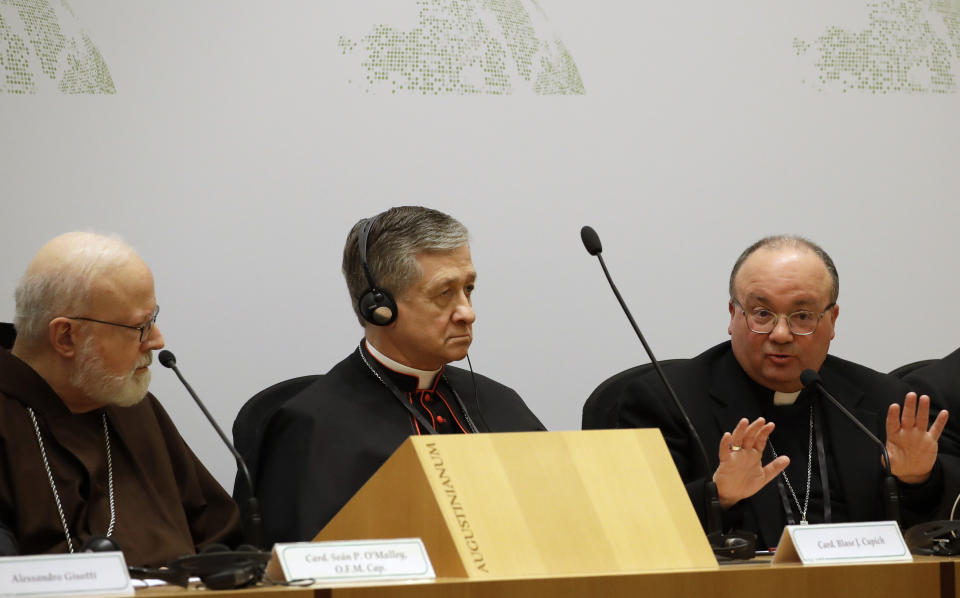 Malta's Archbishop Charles Scicluna, right, answers reporters' questions, flanked by Cardinal Blase J. Cupich, Chicago Archbishop, center, and Cardinal Sean Patrick O'Malley, at a media briefing during a four-day sex abuse summit called by Pope Francis, in Rome, Friday, Feb. 22, 2019. Cardinals attending Pope Francis' summit on preventing clergy sex abuse called Friday for a new culture of accountability in the Catholic Church to punish bishops and religious superiors when they fail to protect their flocks from predator priests. (AP Photo/Alessandra Tarantino)