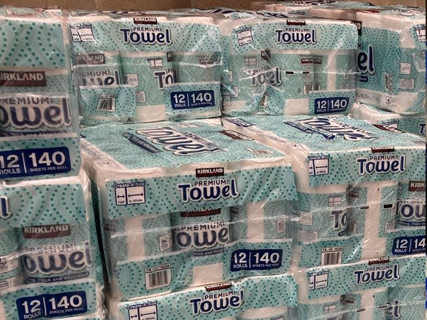 packages of bulk paper towels and packages of bulk toilet paper at costco