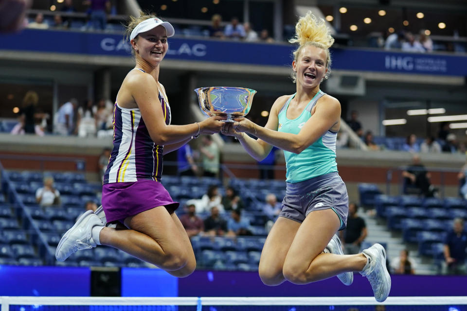 FILE - Barbora Krejcikova, of the Czech Republic, left, and Katerina Siniakova, of the Czech Republic jump with the trophy after defeating Taylor Townsend and Caty McNally, of the United States, in the final of the women's doubles at the U.S. Open tennis championships, Sunday, Sept. 11, 2022, in New York. Total prize money and player compensation at this year’s U.S. Open tennis tournament will reach a record $65 million, the U.S. Tennis Association said Tuesday, Aug. 8, 2023, noting that number is boosted by increases in the amount of expenses covered. (AP Photo/Matt Rourke, File)