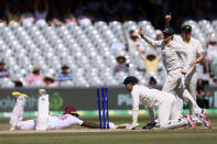 Australia's Alex Carey, second left, runs out the West Indies' Anderson Phillip, left, on the third day of their cricket test match in Adelaide, Saturday, Nov. 10, 2022. (AP Photo/James Elsby)