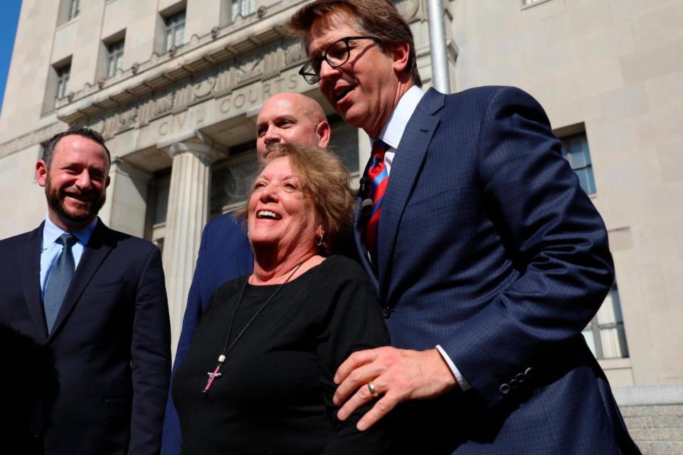 Plaintiff Gail Ingham, foreground, of O'Fallon, Mo., stands outside the civil courthouse with attorneys Lee Cirsch, from left, Eric Holland and Mark Lanier following a verdict against health care giant Johnson & Johnson (AP)