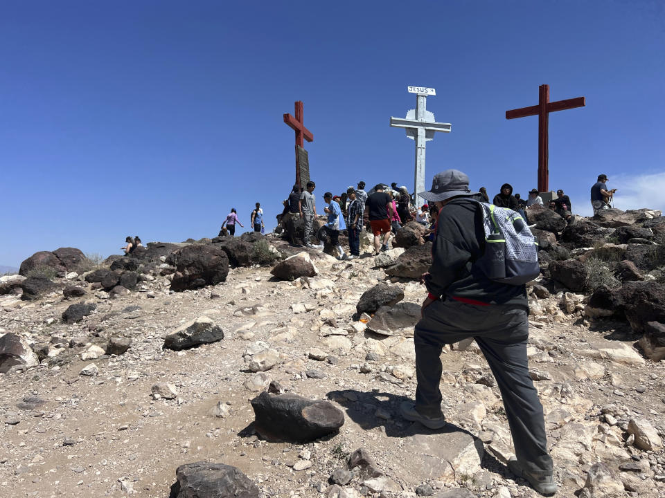 Catholic pilgrims journey to the top of Tome Hill as part of an annual Good Friday pilgrimage, in Los Lunas, N.M., Friday, April 7, 2023. (AP Photo/Felicia Fonseca)