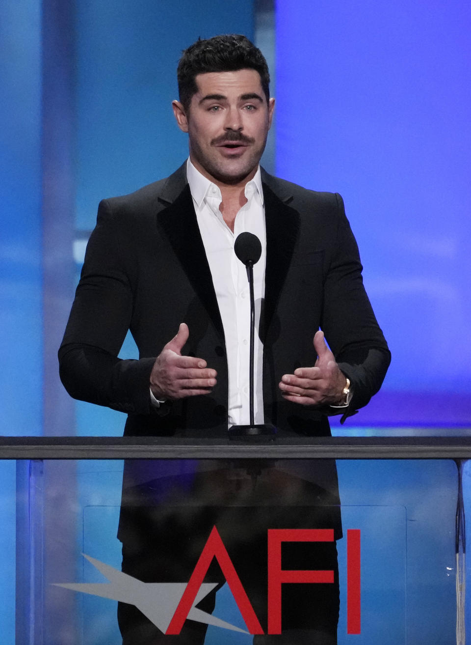 Actor Zac Efron speaks from the stage during the 49th AFI Life Achievement Award tribute to Nicole Kidman, Saturday, April 27, 2024, at the Dolby Theatre in Los Angeles. (AP Photo/Chris Pizzello)