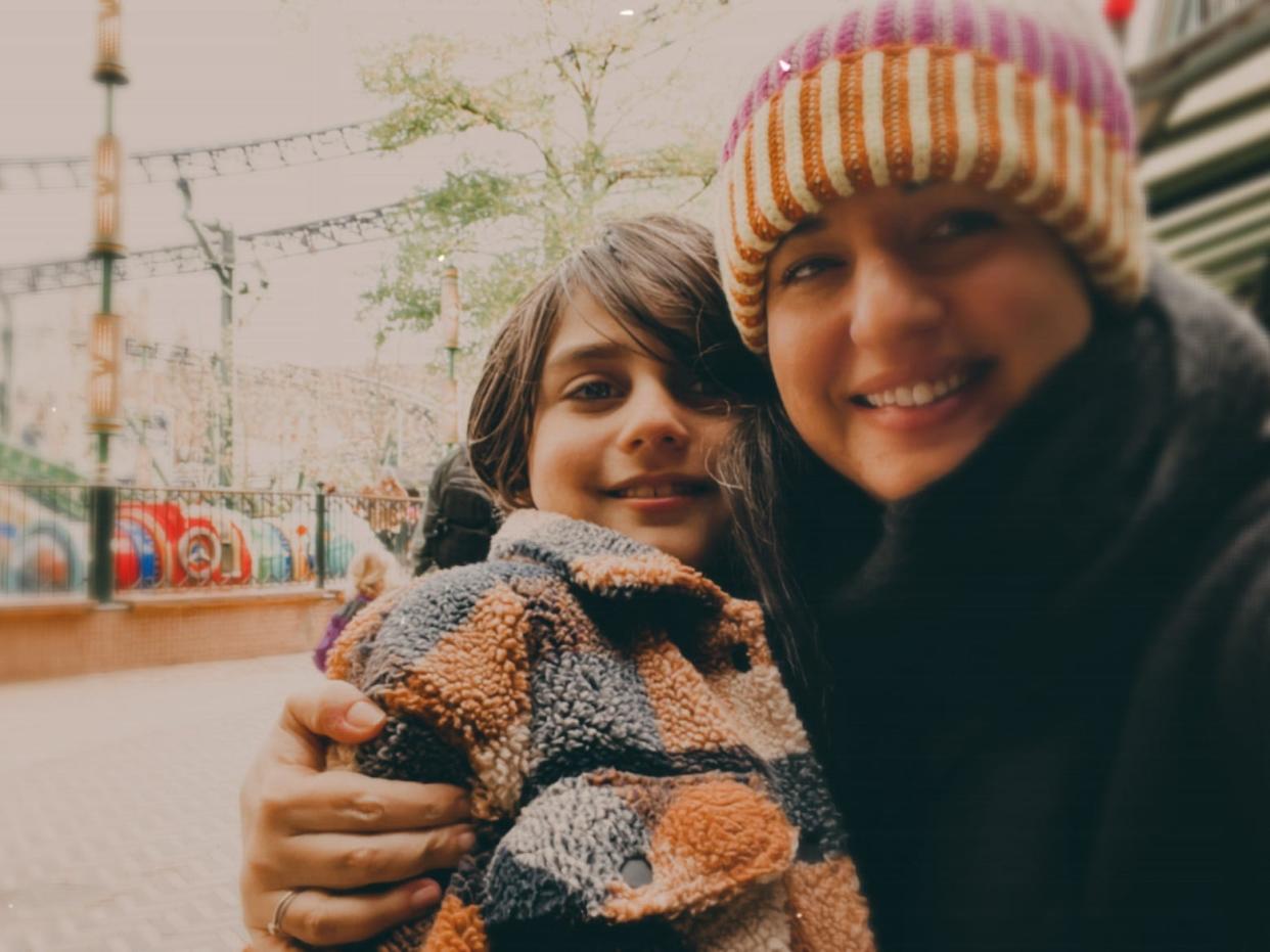 Woman and child smiling for a picture at the Tivoli Gardens in Denmark freelancer photo