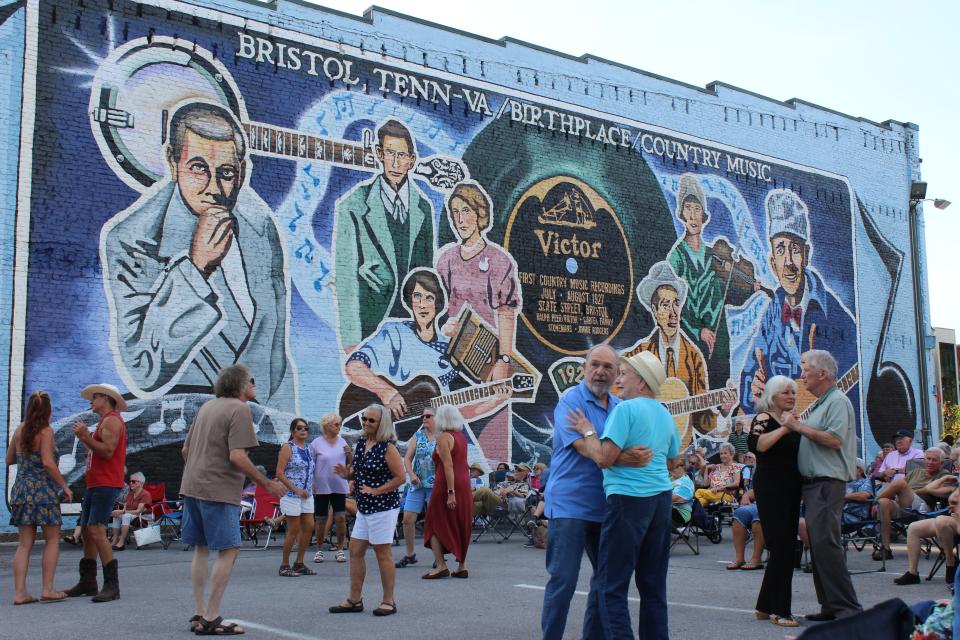 Couples enjoy music at a concert in downtown Bristol, which Congress recognized as the birthplace of country music. Ballad Health is the only option for hospital care in Bristol and the surrounding area.