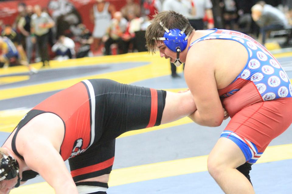 Lakewood's Keegan Jacks wrestles New Philadelphia's Garrett Dillon-Rine in a heavyweight match during the Division II state championships at Ohio State's Schottenstein Center on Saturday, March 9, 2024.