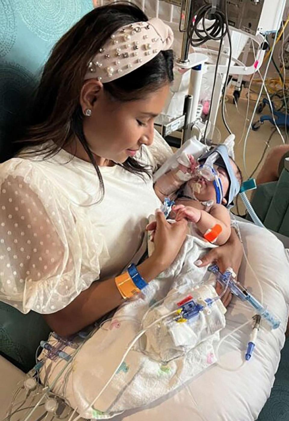 PHOTO: Sandy Fuller holds one of her twin daughters following separation surgery at Texas Children's Hospital. (Texas Children's Hospital)