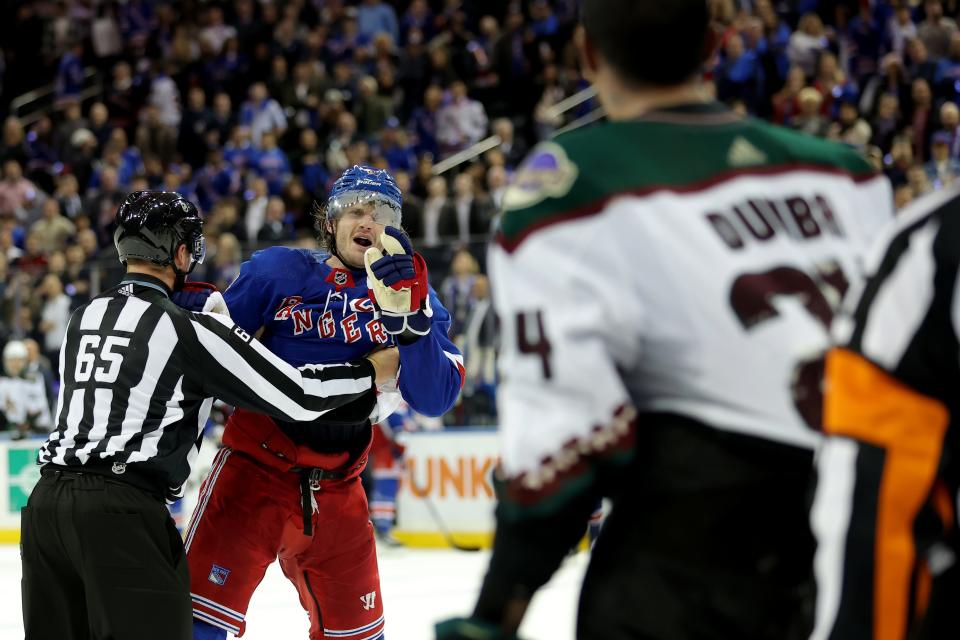 New York Rangers defenseman Jacob Trouba (8) is separated from Arizona Coyotes defenseman Matt Dumba (24) after the Rangers defeated the Coyotes 2-1 at Madison Square Garden in New York on Oct. 16, 2023.