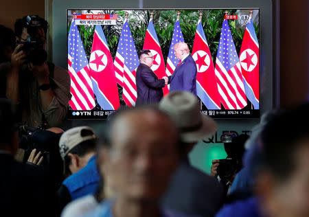 People watch a TV broadcasting a news report on summit between the U.S. and North Korea, in Seoul, South Korea, June 12, 2018. REUTERS/Kim Hong-Ji