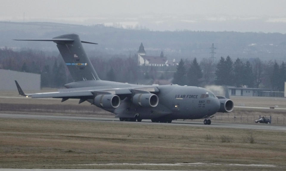 A U.S. Army transport plane landing at the Rzeszow-Jasionka airport in southeastern Poland on Sunday, Feb. 6, 2022, bringing from Fort Bragg troops and equipment of the 82nd Airborne Division. Additional U.S. troops are arriving in Poland after President Joe Biden ordered the deployment of 1,700 soldiers here amid fears of a Russian invasion of Ukraine. Some 4,000 U.S. troops have been stationed in Poland since 2017. (AP Photo/Czarek Sokolowski)
