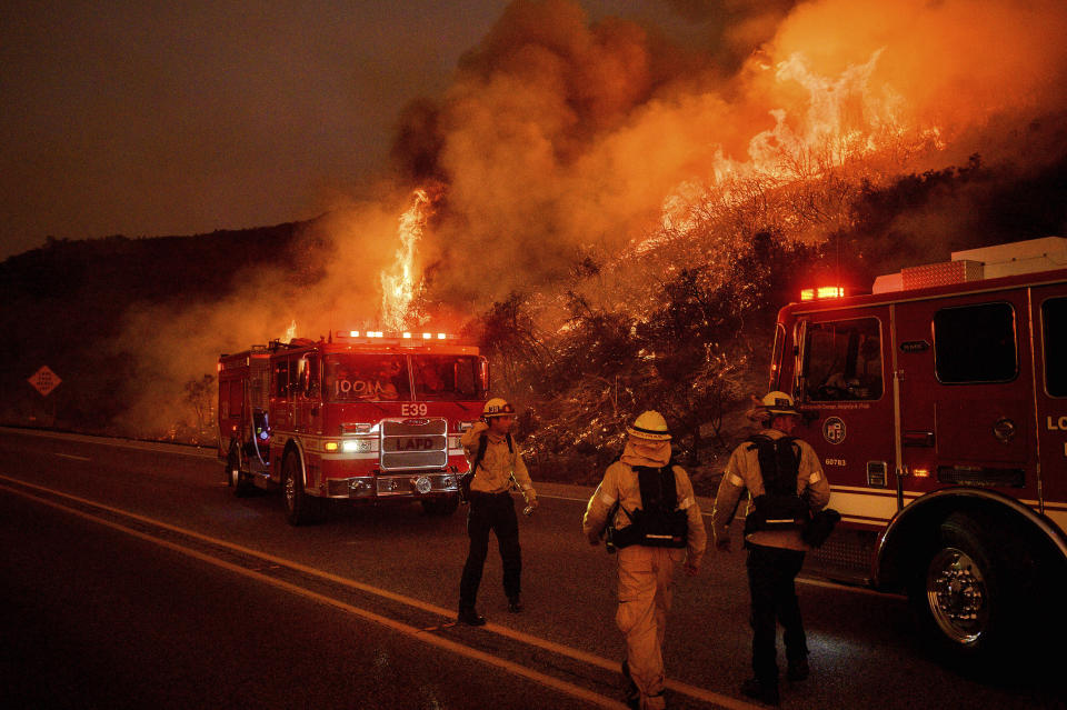Firefighters battle the Cave Fire burn as it flares up along Highway 154 in the Los Padres National Forest, above Santa Barbara, Calif., Tuesday, Nov. 26, 2019. (AP Photo/Noah Berger)