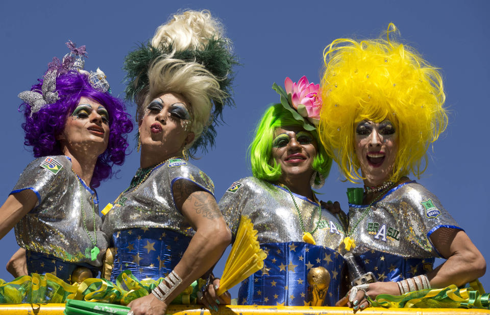 Revelers pose for photos during the annual Gay Pride Parade in Sao Paulo, Brazil, Sunday, May 4, 2014. Gay rights advocates are calling for a Brazilian law against discrimination as they gather by the hundreds of thousands in Sao Paulo for one of the world's largest gay pride parades. (AP Photo/Andre Penner)