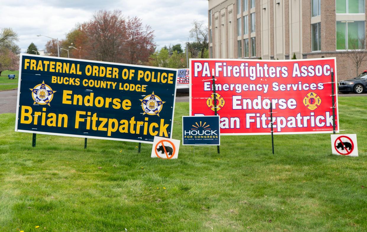 Signs for Republican Brian Fitzpatrick and Mark Houck at a street rally for former President Donald J. Trump in Newtown on Saturday, April 13, 2024.