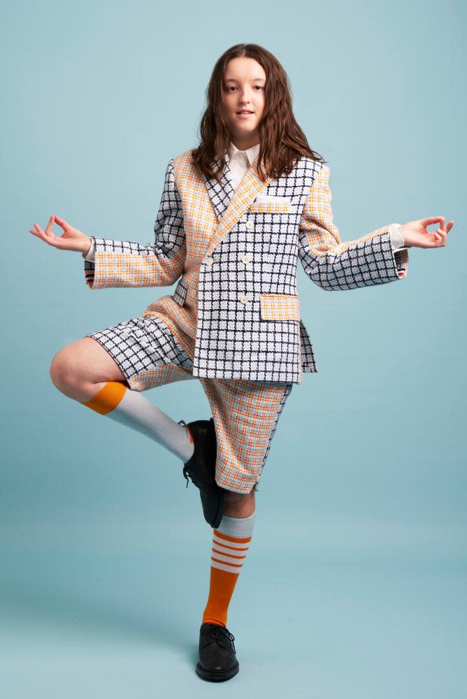 Bella Ramsey photographed for the Guardian. Hair by Earl Simms; Styling by Fabio Immediato; Makeup by Amanda Grossman; shirt, jacket, shorts, socks and shoes by Thom Browne.