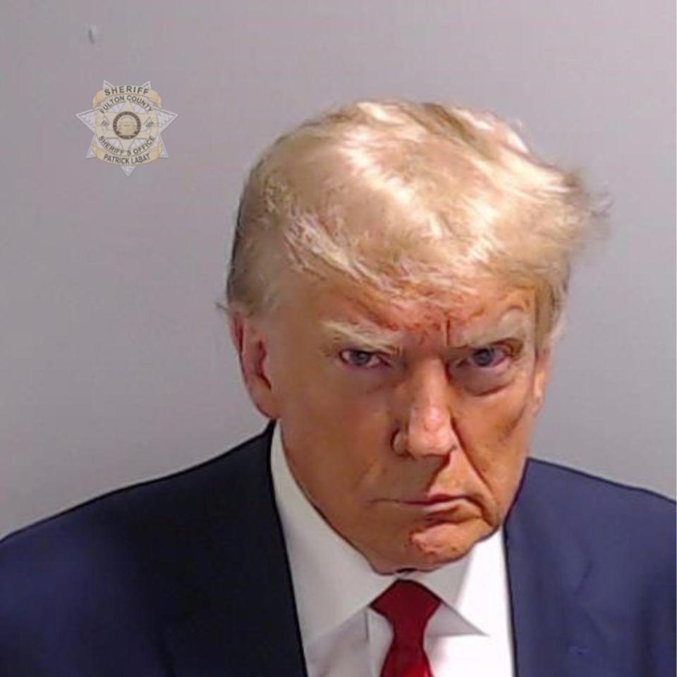 In this handout provided by the Fulton County Sheriff's Office, former U.S. President Donald Trump poses for his booking photo at the Fulton County Jail on August 24, 2023 in Atlanta, Georgia. Trump was booked on 13 charges related to an alleged plan to overturn the results of the 2020 presidential election in Georgia. Trump and 18 others facing felony charges have been ordered to turn themselves in to the Fulton County Jail by Aug. 25.