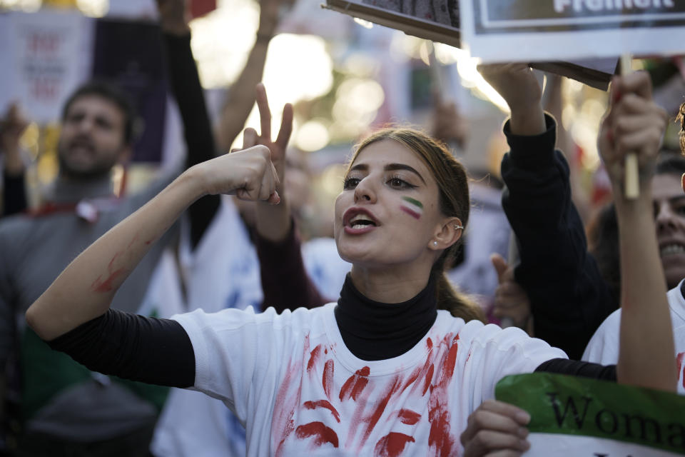 A woman shouts during a protest against the Iranian regime, in Berlin, Germany, Saturday, Oct. 22, 2022, following the death of Mahsa Amini in the custody of the Islamic republic's notorious "morality police". The 22-year-old died in Iran while in police custody on Sept. 16 after her arrest three days prior for allegedly violating its strictly-enforced dress code. (AP Photo/Markus Schreiber)