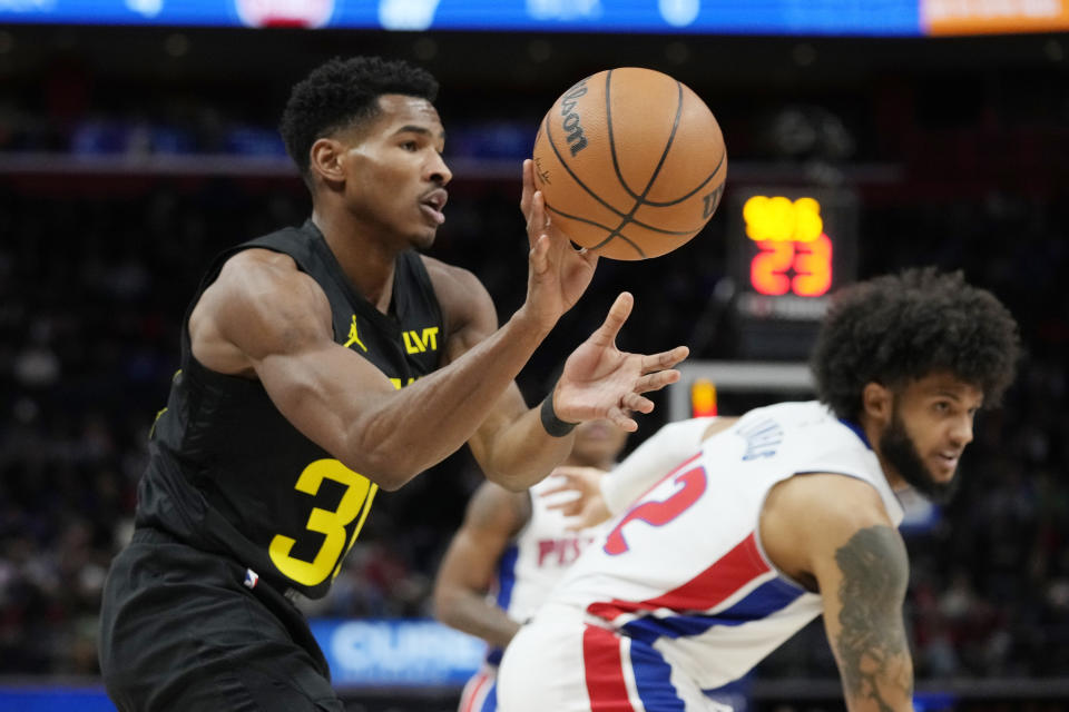 Utah Jazz guard Ochai Agbaji grabs a rebound during the first half of an NBA basketball game against the Detroit Pistons, Thursday, Dec. 21, 2023, in Detroit. (AP Photo/Carlos Osorio)