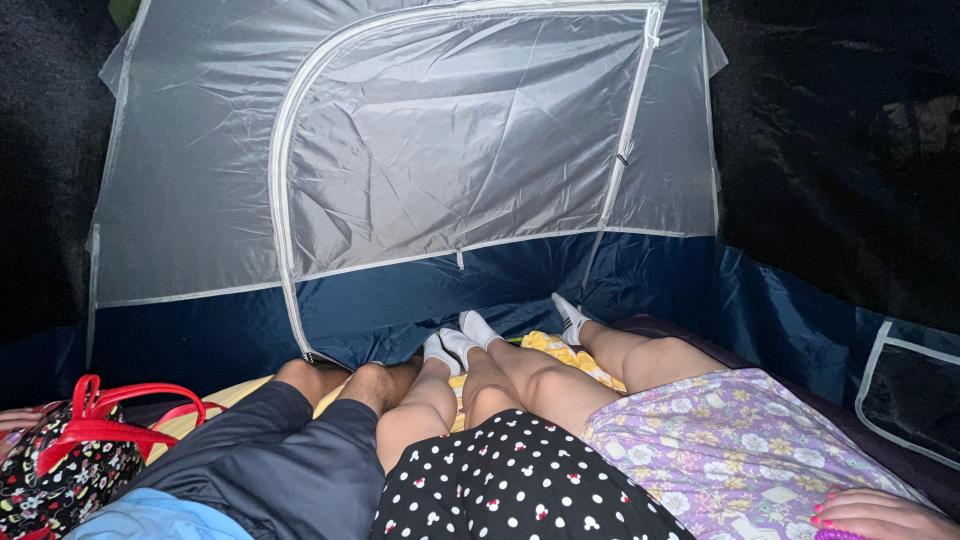 three sets of legs inside tent