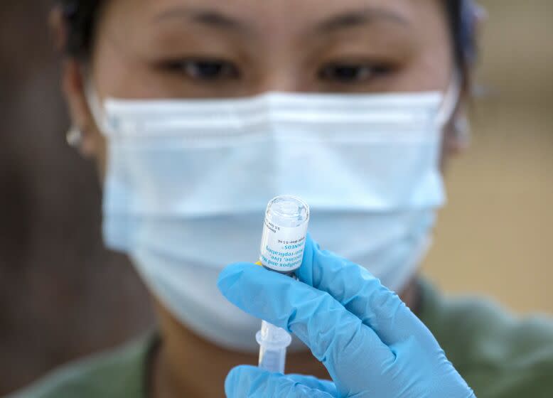 Pharmacist Ngoc-Chau Tran fills syringes with monkeypox vaccine at a walk-up vaccination site at Barnsdall Art Park