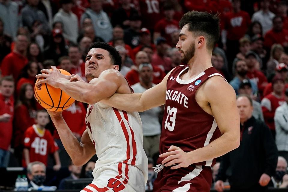 Wisconsin's Johnny Davis is fouled by Colgate's Oliver Lynch-Daniels during the second half of a first-round NCAA college basketball tournament game Friday, March 18, 2022, in Milwaukee. (AP Photo/Morry Gash)