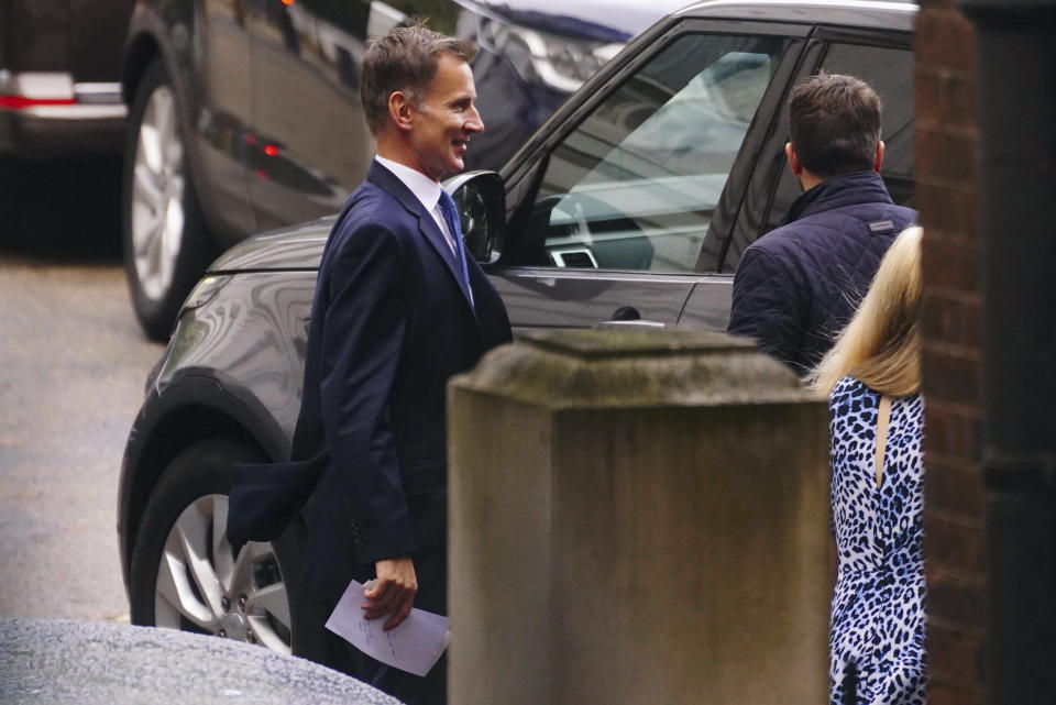 Britain's Chancellor of the Exchequer Jeremy Hunt gets into a car at the rear of Downing Street, before he makes an emergency statement, in London, Monday, Oct. 17, 2022. U.K. Treasury chief Jeremy Hunt has reversed most of an economic package announced by the government just weeks ago including a planned cut to income tax. Hunt said Monday he was scrapping “almost all” the tax cuts announced last month and signaled public spending cuts are on the way. (Victoria Jones/PA via AP)