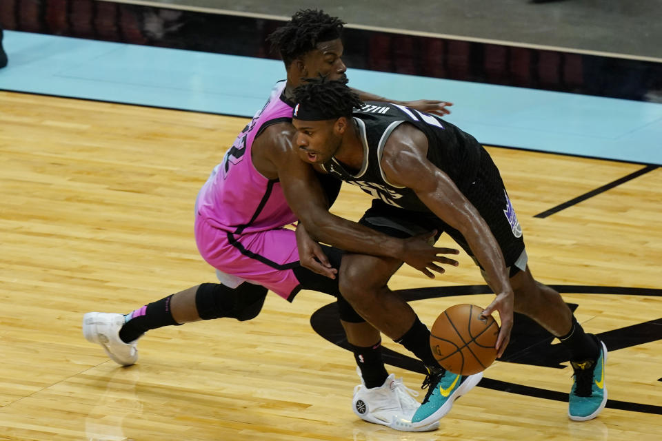 Miami Heat forward Jimmy Butler (22) defends Sacramento Kings guard Buddy Hield (24) during the second half of an NBA basketball game, Saturday, Jan. 30, 2021, in Miami. (AP Photo/Marta Lavandier)