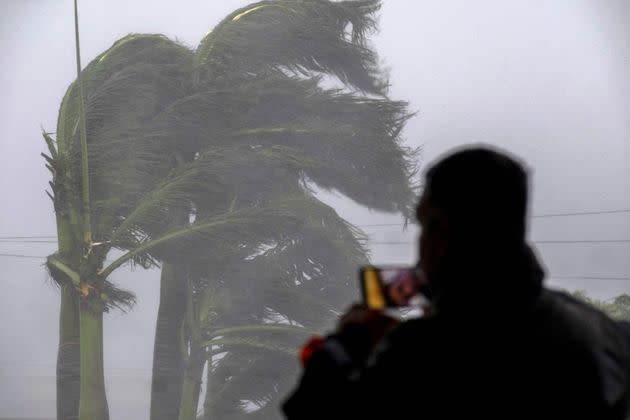 A man livestreams as gusts from Hurricane Ian hit Punta Gorda on Wednesday. (Photo: RICARDO ARDUENGO via Getty Images)