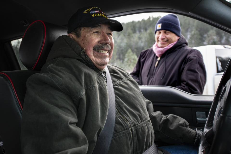 Richard King, 70, left, and his brother, Brent, laugh together while Brent takes a break searching for a Christmas tree on the King family ranch on Sunday, Dec. 8, 2019. Both brothers served in the military, with Richard serving in the the U.S. Navy and Brent in the Marines. Richard says, “If children tell their parents that the clerics abused you, I would probably have gotten a whipping. I would have gotten one at church and one at home. ... They’d say ‘shut up, that doesn’t happen.’” (AP Photo/Tommy Martino)