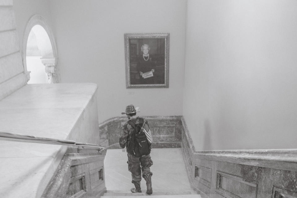 A pro-Trump rioter walks down a staircase after breaking into the Capitol.<span class="copyright">Christopher Lee for TIME</span>