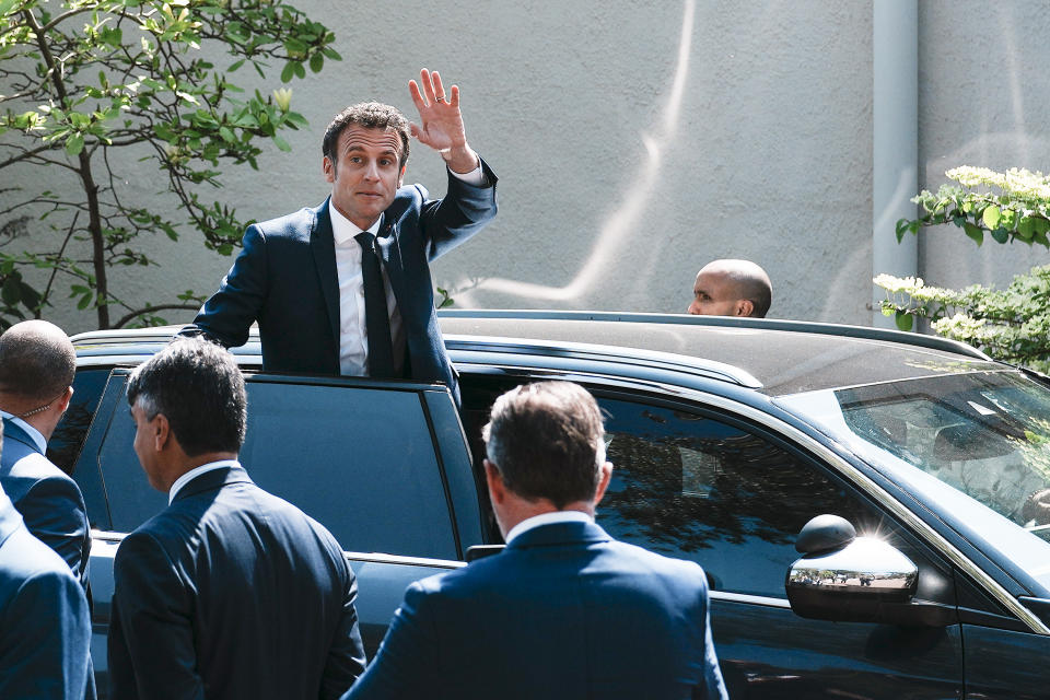 French President and centrist candidate Emmanuel Macron waves from his car after casting his vote in Le Touquet, northern France, Sunday, April 24, 2022. France began voting in a presidential runoff election Sunday with repercussions for Europe's future, with centrist incumbent Emmanuel Macron the front-runner but fighting a tough challenge from far-right contender Marine Le Pen. (AP Photo/Thibault Camus)