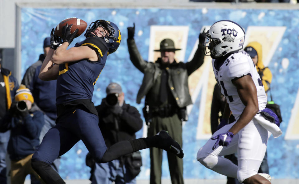 West Virginia wide receiver David Sills V (13) misses a catch while being defended by TCU safety Ridwan Issahaku (31) during the first half of an NCAA college football game Saturday, Nov. 10, 2018, in Morgantown, W.Va. (AP Photo/Raymond Thompson)