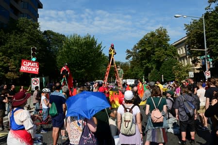 Climate change activists block traffic at an intersection in downtown Washington