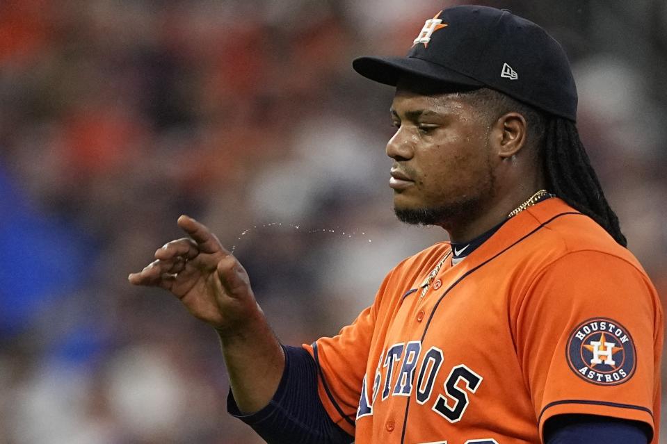 Houston Astros starting pitcher Framber Valdez reacts after giving up a two-run home run to Texas Rangers' Jonah Heim during the fourth inning of Game 6 of the baseball AL Championship Series Sunday, Oct. 22, 2023, in Houston. (AP Photo/David J. Phillip)