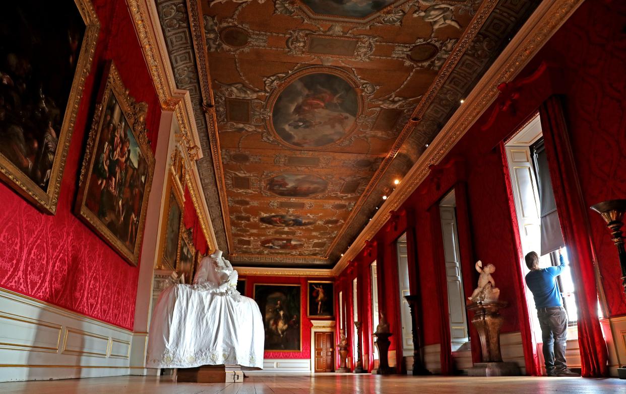 A Historic Royal Palaces Conservator opens the blinds in the King's Gallery ahead of the re-opening of Kensington Palace to the public tomorrow on July 29, 2020, in London, England.