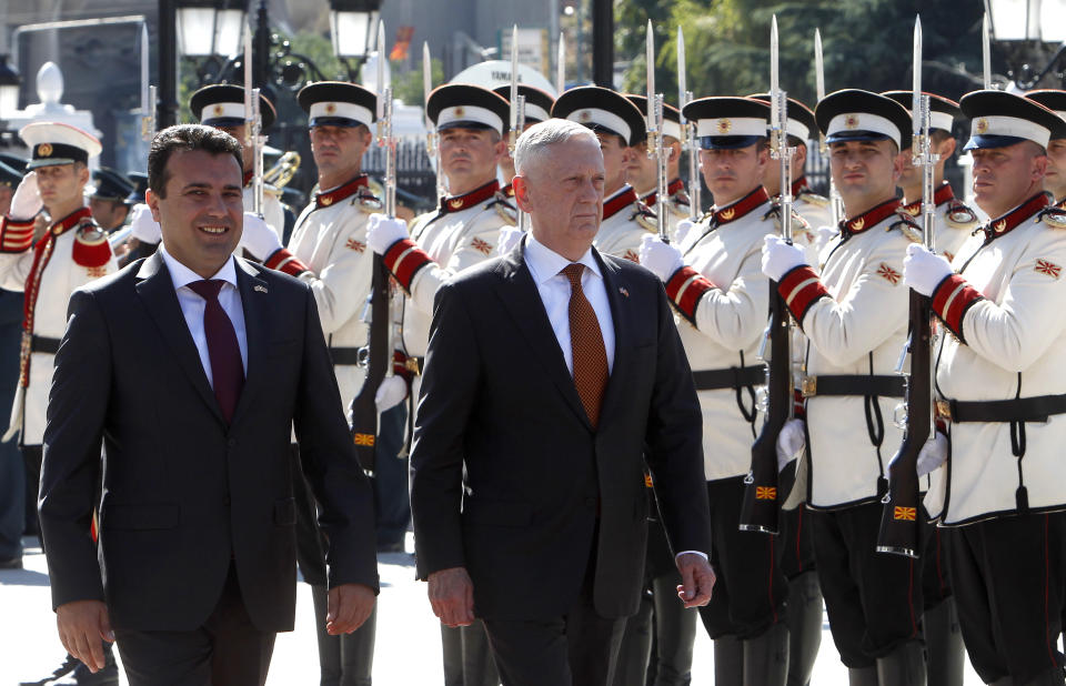 U.S. Defense Secretary James Mattis, center, accompanied by Macedonian Prime Minister Zoran Zaev, left, walk past an honor guard, upon his arrival at the government building in Skopje, Macedonia, Monday, Sept. 17, 2018. Mattis arrived in Macedonia Monday, condemning Russian efforts to use its money and influence to build opposition to an upcoming vote that could pave the way for the country to join NATO, a move Moscow opposes. (AP Photo/Boris Grdanoski)