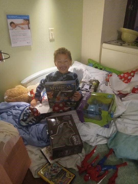 Evan Whittaker with his new toys at Children's Wisconsin