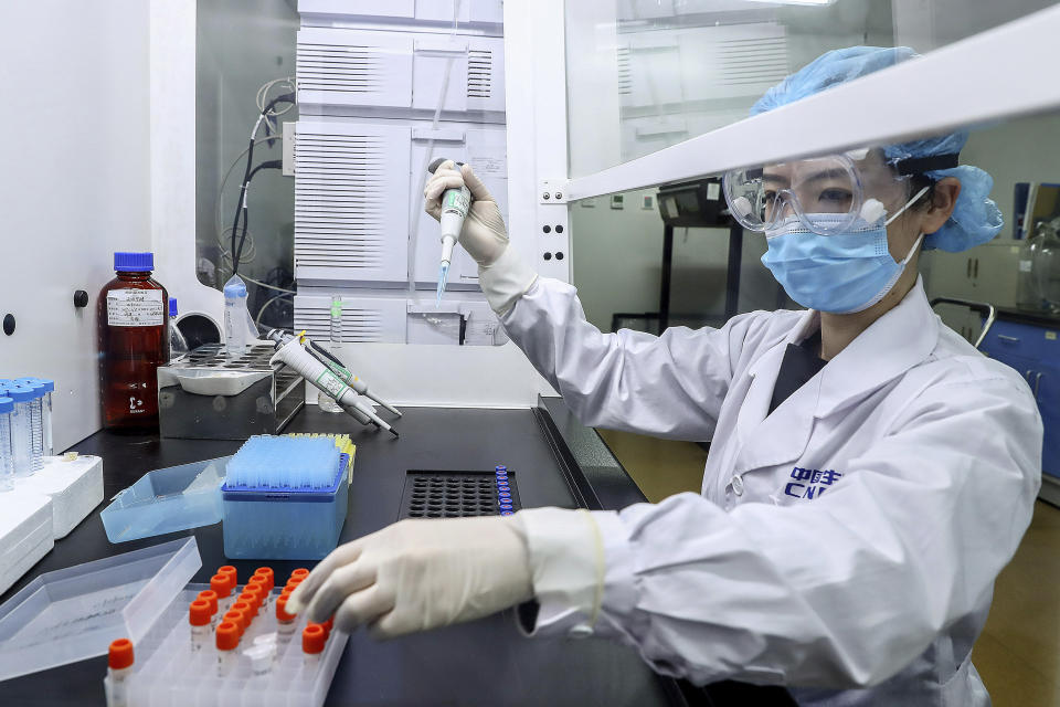 In this April 11, 2020, photo released by Xinhua News Agency, a staff member tests samples of a potential COVID-19 vaccine at a production plant of SinoPharm in Beijing. In the global race to make a coronavirus vaccine, the state-owned Chinese company is boasting that it gave its employees, including top executives, experimental shots even before the government OK'd testing in people. (Zhang Yuwei/Xinhua via AP)