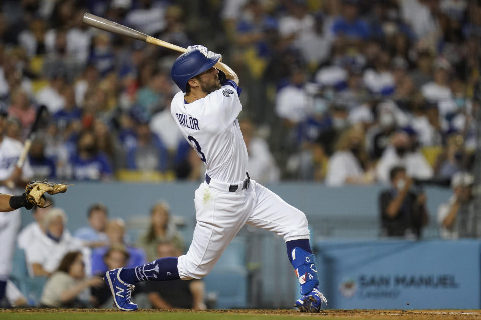 Los Angeles Dodgers' Chris Taylor hits a sacrifice fly to left field during the fourth inning of a baseball game against the San Diego Padres Friday, Sept. 10, 2021, in Los Angeles. Will Smith scored. (AP Photo/Ashley Landis)