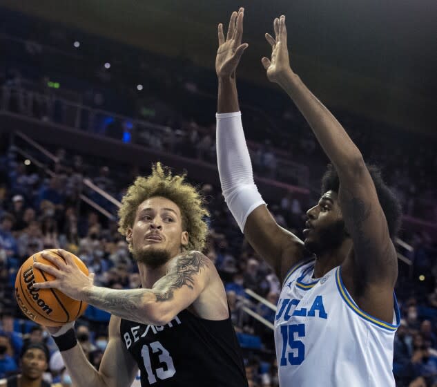 WESTWOOD, CA - November 15 2021: Long Beach State's Romelle Mansel, #13, drives to the basket past Bruins Myles Johnson, #15 during first half at Pauley Pavilion on Monday, Nov. 15, 2021 in Westwood, CA. (Brian van der Brug / Los Angeles Times