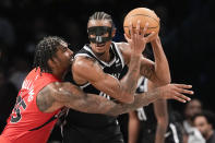 Toronto Raptors center Malik Williams (35) guards Brooklyn Nets center Nic Claxton during the second half of an NBA basketball game, Wednesday, April 10, 2024, in New York. The Nets won 106-102. (AP Photo/Mary Altaffer)
