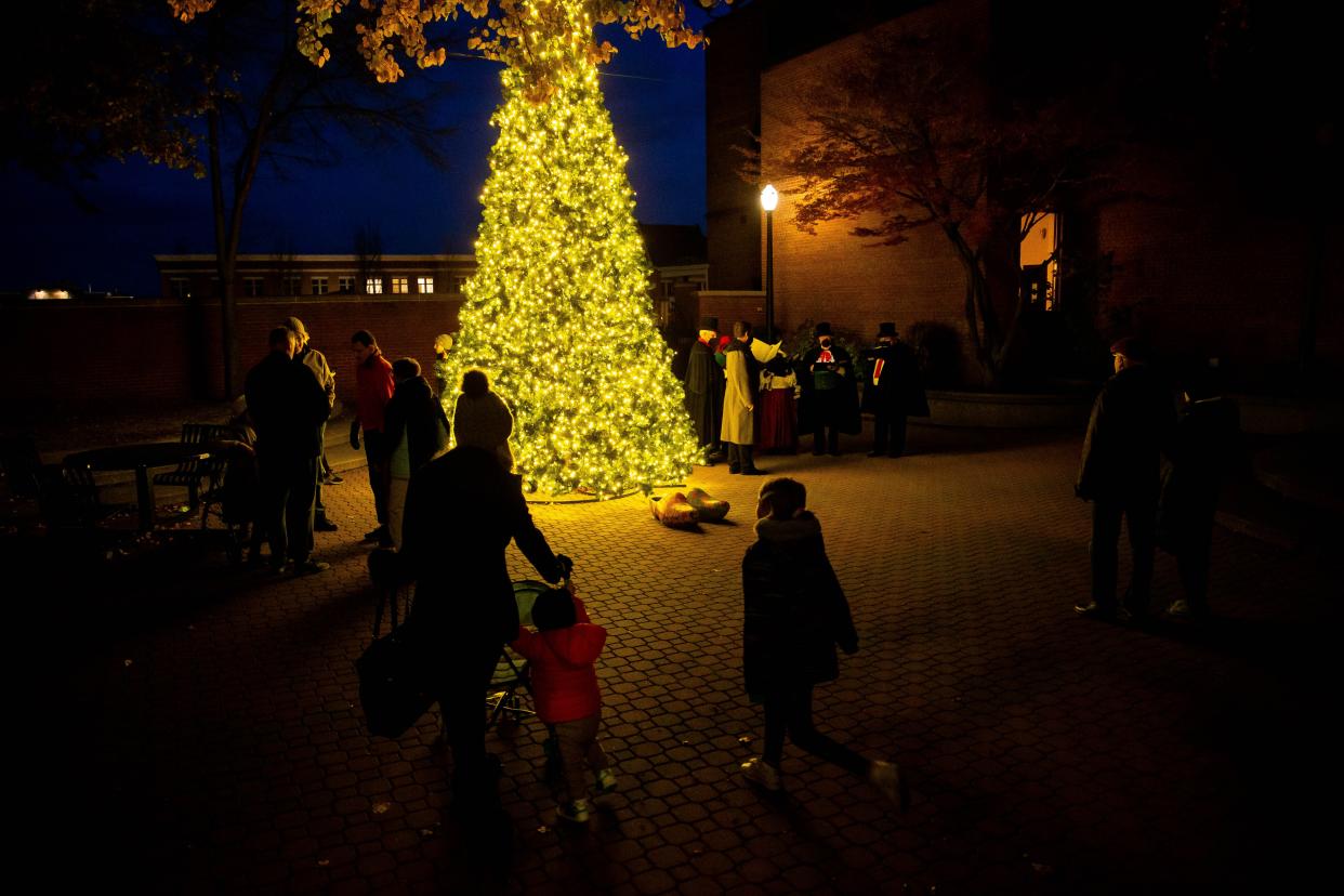 Onlookers enjoy downtown Holland's new, brightly lit Christmas tree during a Holiday Open House in November 2021.