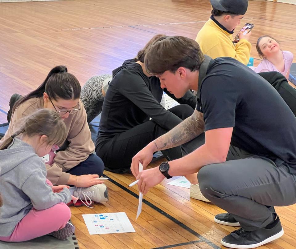 Dalhousie University hockey player Alec Bélanger, right, is the recipient of this year's Atlantic University Sport student-athlete community service award. He started a program that pairs student volunteers with children with Down syndrome and their siblings, offering them a place to play and do activities. (Richard Woodbury/CBC - image credit)