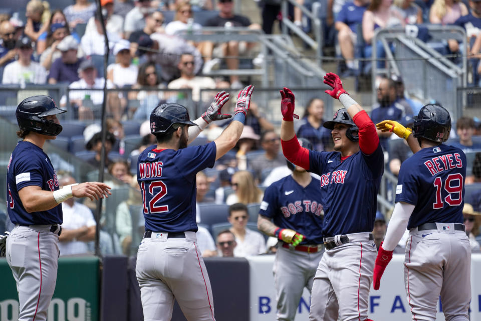 Boston Red Sox's Luis Urias, second from right, celebrates with Pablo Reyes (19), Connor Wong (12) and Jarren Duran after they scored of Urias' grand slam in the second inning of a baseball game. against the New York Yankees, Saturday, Aug. 19, 2023, in New York. (AP Photo/Mary Altaffer)