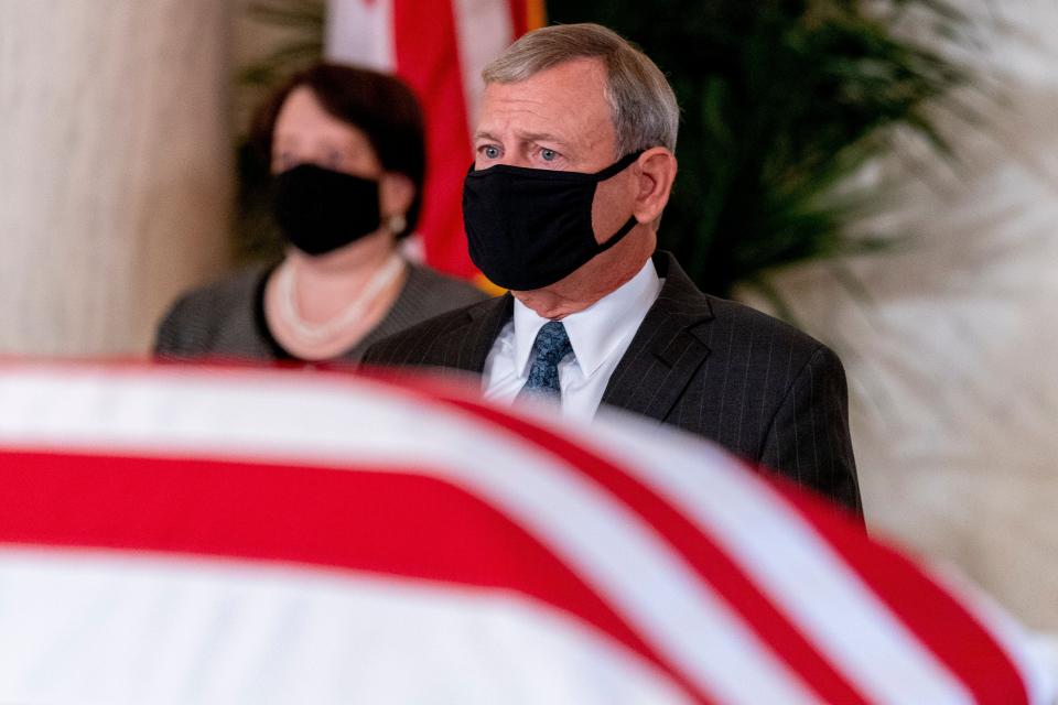 John Roberts and Elena Kagan wear face masks behind the flag-draped casket of Ruth Bader Ginsburg