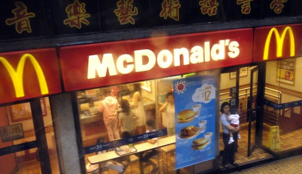 A woman and child walk out of a McDonald's restaurant in Hon