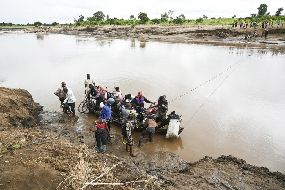 Men transport their salvaged belongings in Chiradzulu, southern Malawi, Friday March 17, 2023. Authorities are still getting to grips with the scale of Cyclone Freddy's destruction in Malawi and Mozambique since late Saturday, with over 300 people confirmed dead and several hundreds still displaced or missing. (AP Photo/Thoko Chikondi)