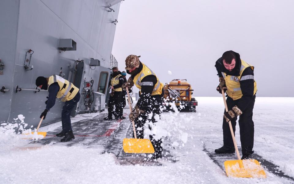 Crew members clear the decks of HMS Prince of Wales as Arctic conditions strike - @HMSPWLS